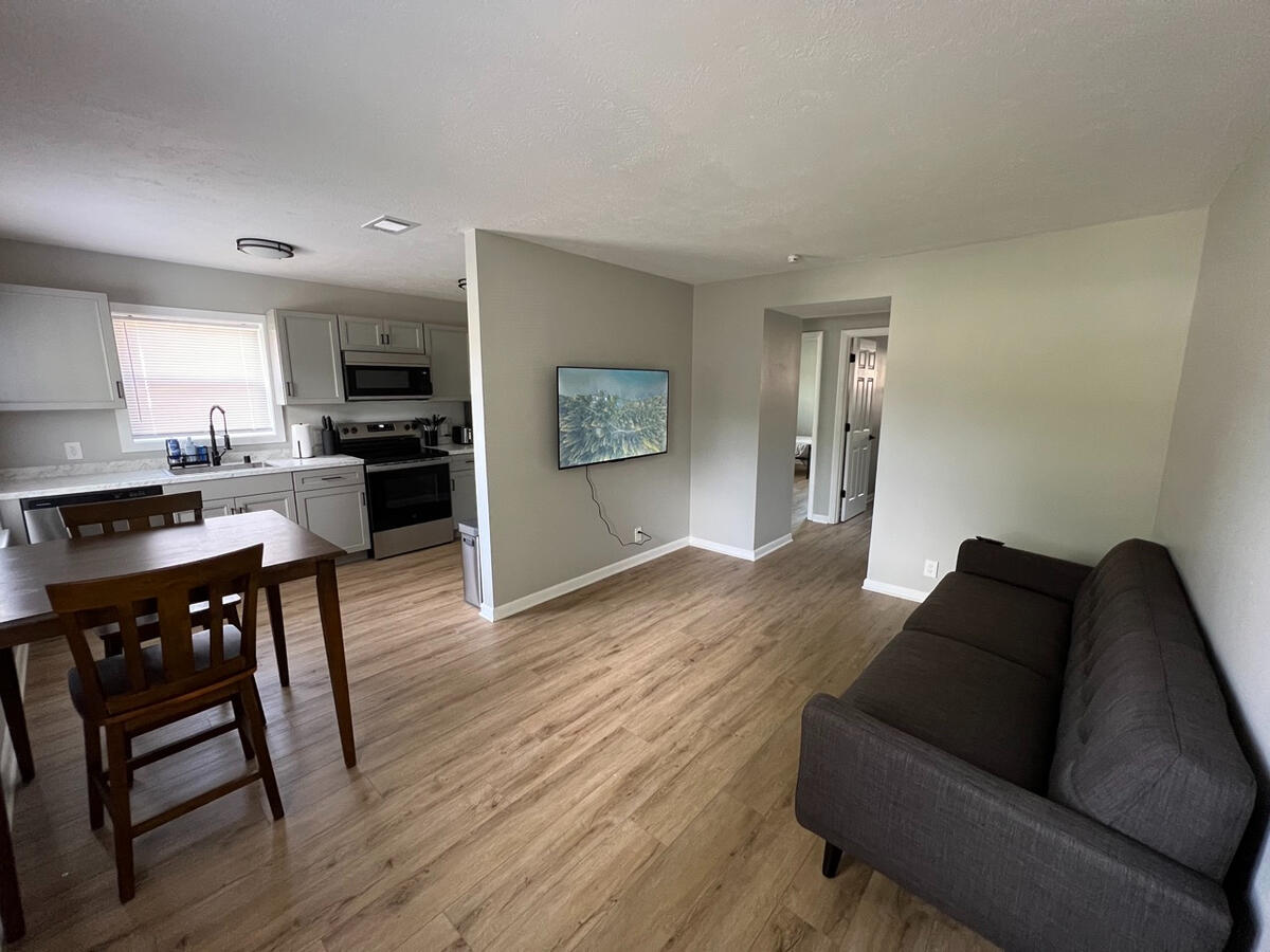 Spacious shared living room for pilots and flight attendants to relax between trips at our Louisville crashpad near SDF.